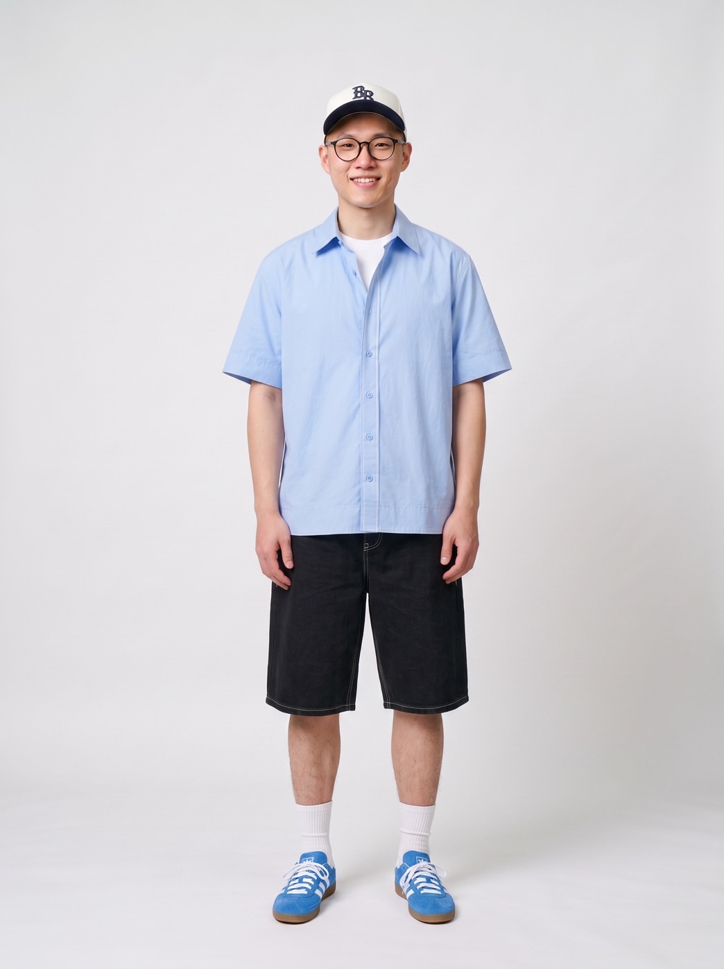 A Style Sketch outfit suggestion: a pale blue short-sleeved shirt with black shorts, blue trainers and a cap.